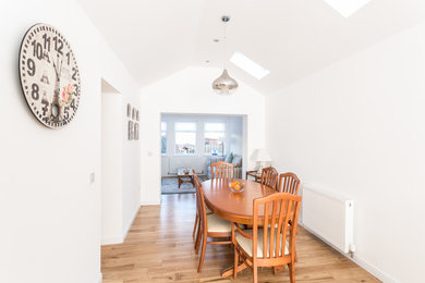 Idées déco pour une petite salle à manger ouverte sur le salon classique avec un mur blanc et parquet clair.