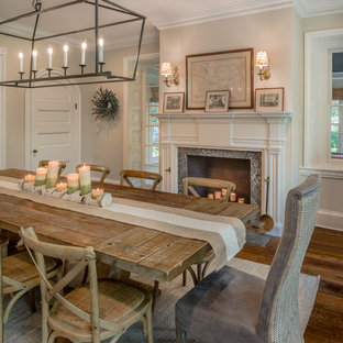 Ispirazione per una grande sala da pranzo country con pareti grigie, pavimento in legno massello medio, camino classico, cornice del camino in pietra e pavimento marrone
