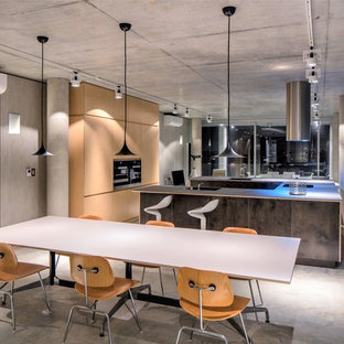 This is an example of an industrial open plan dining in Perth with grey walls, concrete floors and grey floor.