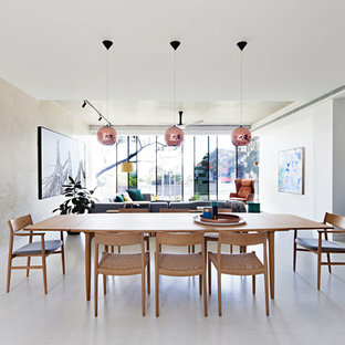 Photo of a contemporary open plan dining in Melbourne with beige walls and grey floor.