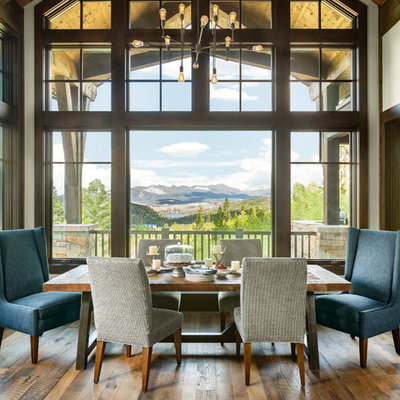 Inspiration for a rustic medium tone wood floor dining room remodel in Denver with white walls and no fireplace