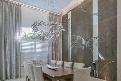 Enclosed dining room - mid-sized modern ceramic tile and gray floor enclosed dining room idea in Miami with gray walls