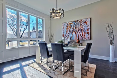 Mid-sized minimalist dark wood floor enclosed dining room photo in Calgary with gray walls