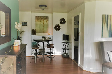 Example of a small beach style medium tone wood floor enclosed dining room design in Hawaii with blue walls