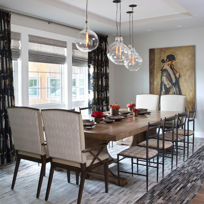 Inspiration for a transitional dark wood floor and brown floor enclosed dining room remodel in Denver with gray walls