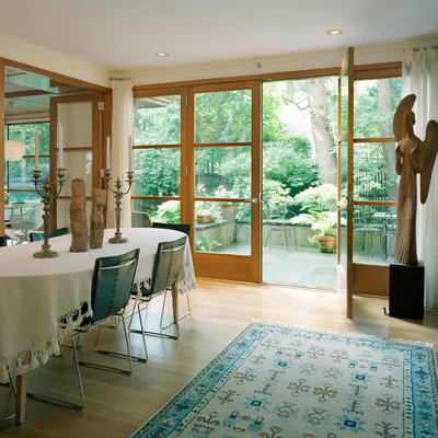 Great room - mid-sized traditional light wood floor great room idea in Boston with white walls, a standard fireplace and a stone fireplace