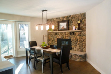 Mid-sized urban dark wood floor kitchen/dining room combo photo in Minneapolis with gray walls, a standard fireplace and a stone fireplace