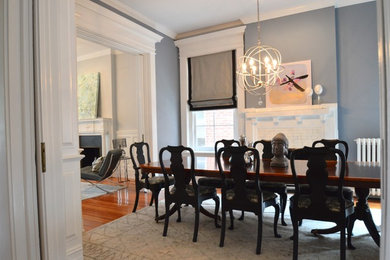 This is an example of a medium sized traditional dining room in Richmond with blue walls, medium hardwood flooring, a standard fireplace, a brick fireplace surround and brown floors.
