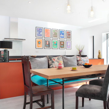 Modern orange kitchen with banquette seating