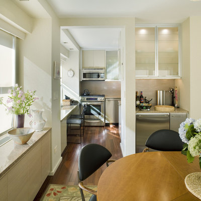 Example of a trendy dark wood floor kitchen/dining room combo design in New York with beige walls