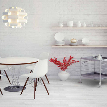 Modern white dining area with light colored porcelain floors