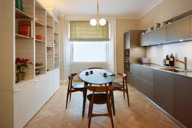 Design ideas for a contemporary dining room in London with beige walls.