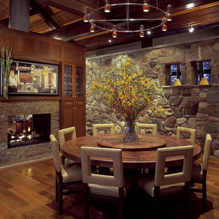 Dining room - rustic dining room idea in Charleston with a two-sided fireplace