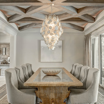 Example of a transitional medium tone wood floor and gray floor dining room design in Charlotte with gray walls