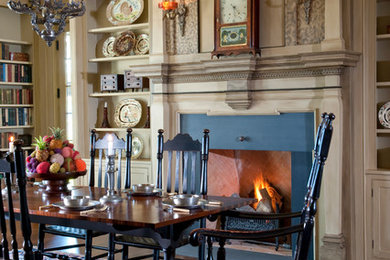 Enclosed dining room - traditional medium tone wood floor enclosed dining room idea in Boston with a standard fireplace and a stone fireplace