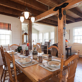 Foto de comedor costero con paredes blancas y suelo de madera oscura