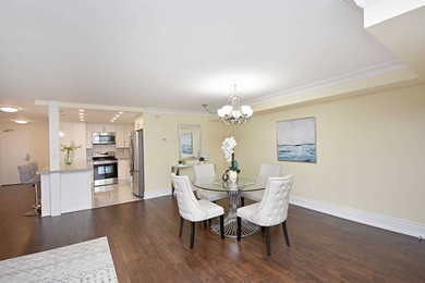 Great room - transitional dark wood floor and brown floor great room idea in Toronto with yellow walls and no fireplace