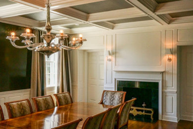 Large elegant medium tone wood floor enclosed dining room photo in New York with white walls, a standard fireplace and a tile fireplace