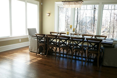 Example of a large dark wood floor great room design in Columbus with beige walls and no fireplace