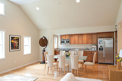 Great room - mid-sized modern medium tone wood floor great room idea in Bridgeport with white walls