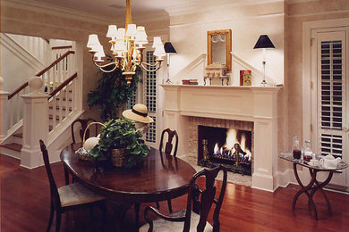 Enclosed dining room - mid-sized traditional dark wood floor and brown floor enclosed dining room idea in Cleveland with white walls, a standard fireplace and a brick fireplace