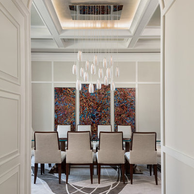 Enclosed dining room - large transitional medium tone wood floor and brown floor enclosed dining room idea in Miami with beige walls