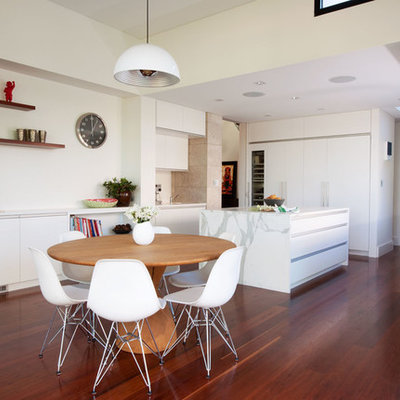 Example of a trendy dark wood floor kitchen/dining room combo design in Sydney with white walls