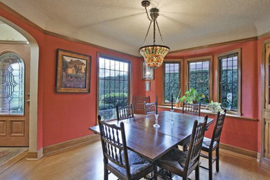 Inspiration for a timeless enclosed dining room remodel in Portland with red walls
