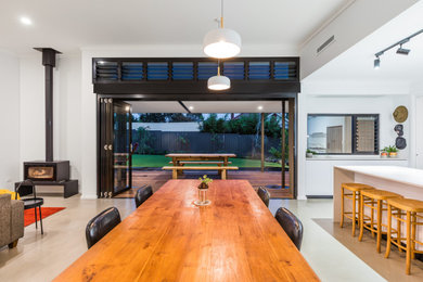 Example of a mid-sized minimalist dining room design in Perth with white walls
