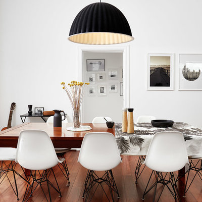 Mid-sized trendy medium tone wood floor and red floor enclosed dining room photo in Perth with white walls and no fireplace