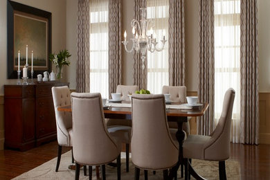 Example of a mid-sized transitional medium tone wood floor enclosed dining room design in Salt Lake City with beige walls