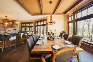 Kitchen/dining room combo - huge rustic dark wood floor and brown floor kitchen/dining room combo idea in New York with brown walls and no fireplace
