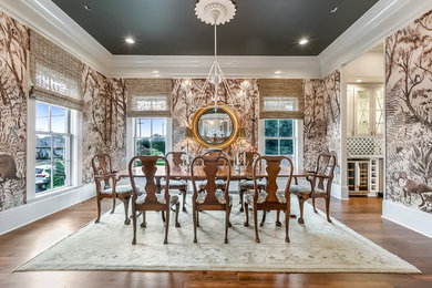 Large traditional enclosed dining room in New Orleans with brown walls, medium hardwood flooring, no fireplace and brown floors.