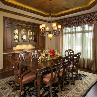 Elegant dark wood floor dining room photo in Milwaukee with beige walls