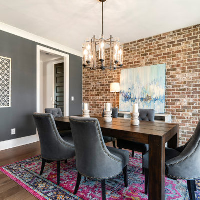 Inspiration for a transitional medium tone wood floor and brown floor enclosed dining room remodel in Nashville with gray walls and no fireplace