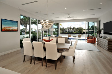 Great room - transitional light wood floor great room idea in Miami with gray walls