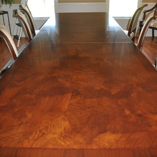 Example of a large classic medium tone wood floor dining room design in Newark with beige walls