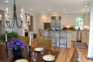 Inspiration for a mid-sized timeless light wood floor and brown floor kitchen/dining room combo remodel in Boston with white walls and no fireplace