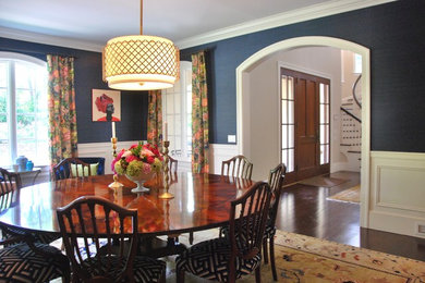 Large elegant medium tone wood floor and brown floor enclosed dining room photo in New York with blue walls and no fireplace