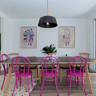 Design ideas for a mid-sized eclectic kitchen/dining combo in Sydney with medium hardwood floors, brown floor and white walls.