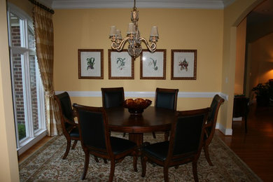 Example of a classic dining room design in Charlotte