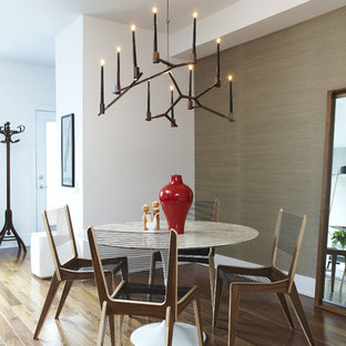 Photo of a small contemporary open plan dining room in Toronto with medium hardwood flooring, brown walls, no fireplace and brown floors.
