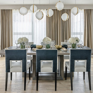 Inspiration for a medium sized contemporary open plan dining room in London with light hardwood flooring, no fireplace and beige walls.