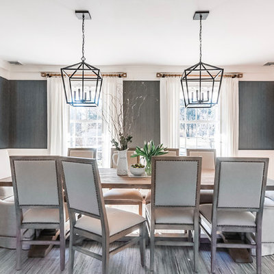 Example of a large transitional medium tone wood floor and brown floor enclosed dining room design in Newark with gray walls and no fireplace