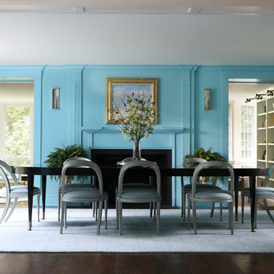 Inspiration for a large transitional dark wood floor and brown floor enclosed dining room remodel in New York with blue walls, a standard fireplace and a wood fireplace surround