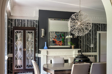 Large trendy medium tone wood floor enclosed dining room photo in Raleigh with gray walls and a metal fireplace