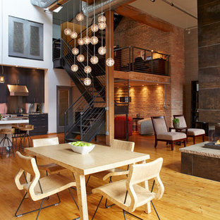 Inspiration for an industrial medium tone wood floor and brown floor great room remodel in Minneapolis with white walls, a two-sided fireplace and a tile fireplace