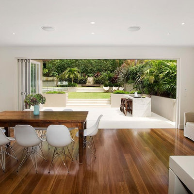 Inspiration for a contemporary medium tone wood floor great room remodel in Sydney with white walls