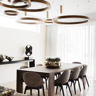 Photo of a contemporary dining room in Melbourne with white walls and beige floor.