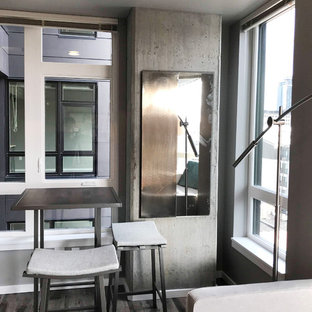 Example of a small mid-century modern laminate floor and brown floor kitchen/dining room combo design in Seattle with gray walls and no fireplace